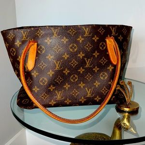 Louis Vuitton over shoulder bag with zip closure and hook for wallet.